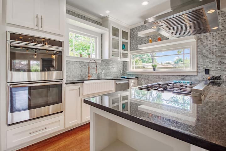 An image of a modern kitchen with sleek appliances, featuring a gas stove, refrigerator, and built-in microwave in Raleigh