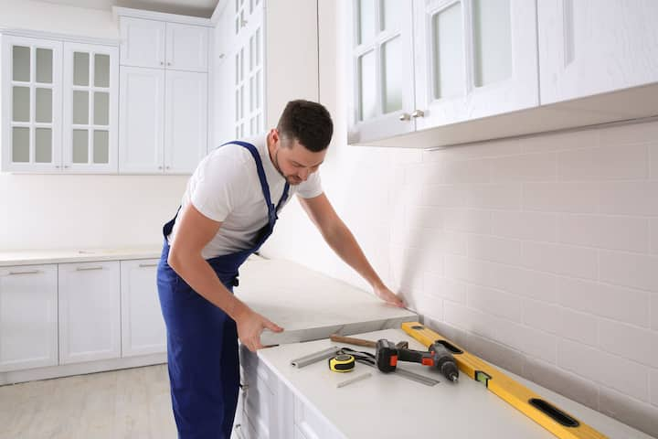 A kitchen remodeling expert installs countertops in a Raleigh home.